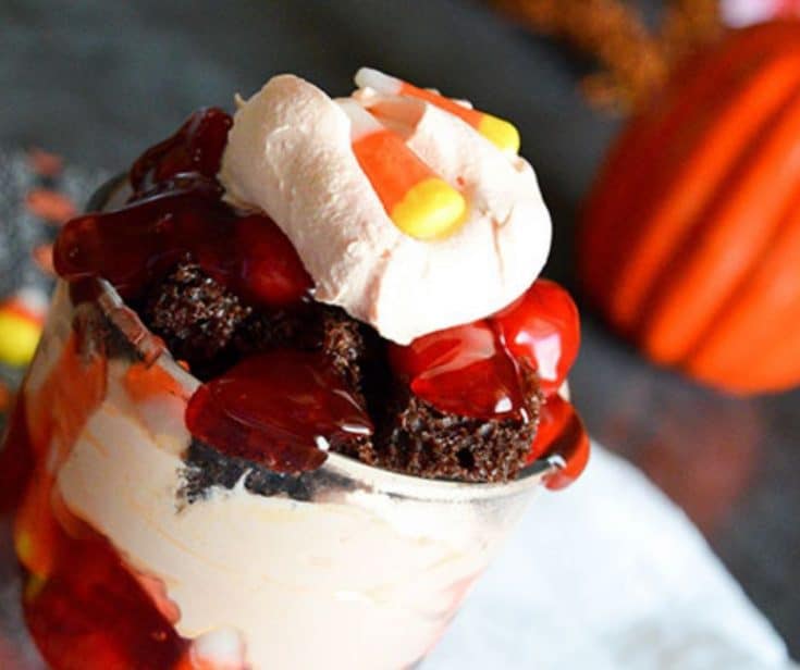 chocolate cherry trifle with cream and candy corn cup