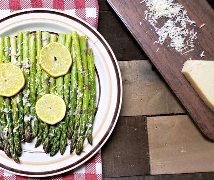 plated keto side dish of garlic roasted asparagus topped with lemon and parmesan cheese