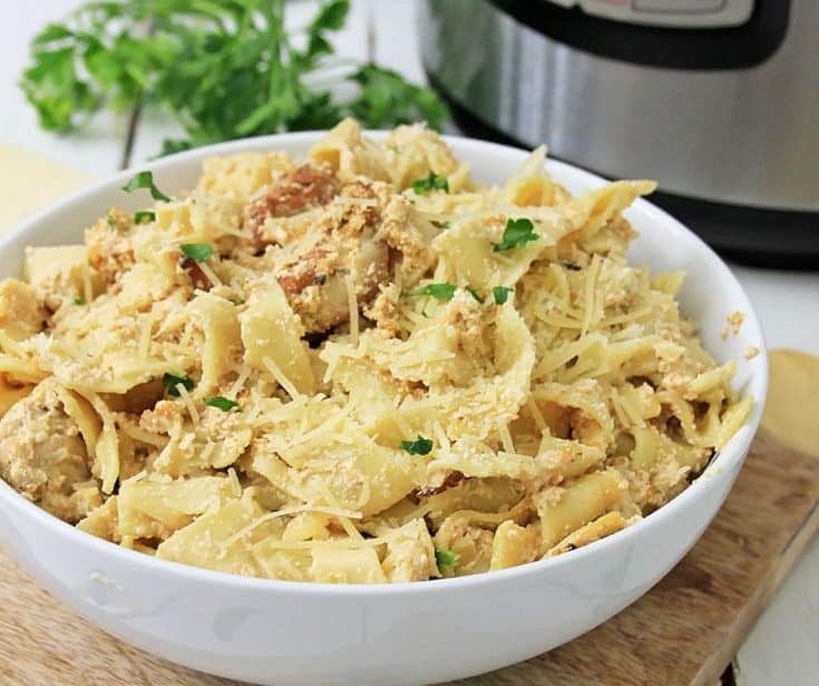 bowl of fettuccine chicken alfredo in front of instant pot